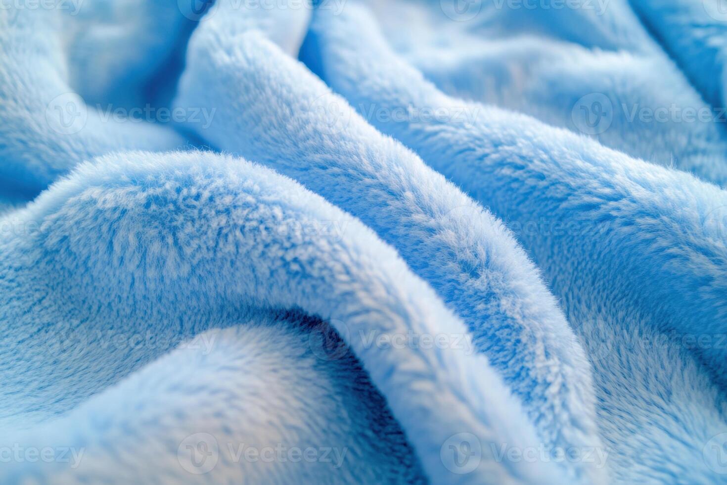 Soft blue fleece blanket draped gently on a surface showcasing its texture and color nuances photo