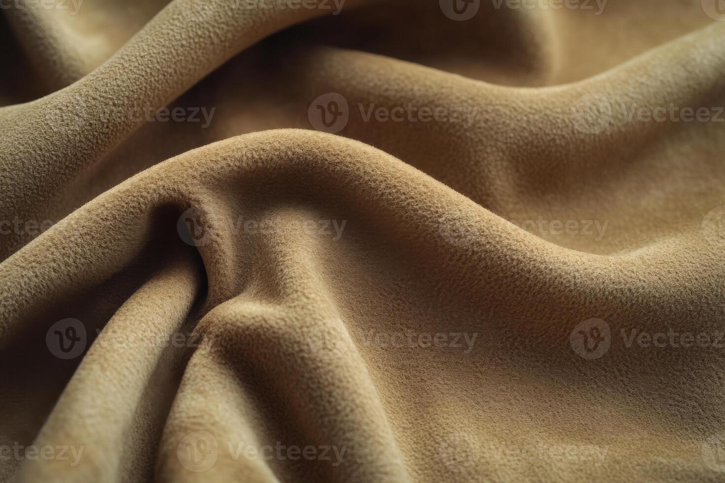 Soft brown fabric drapes elegantly on a textured surface in natural light photo