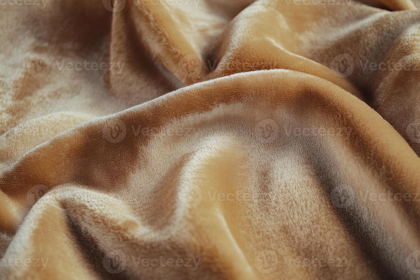 Soft golden fabric draped elegantly on a flat surface, enhancing texture and warmth photo