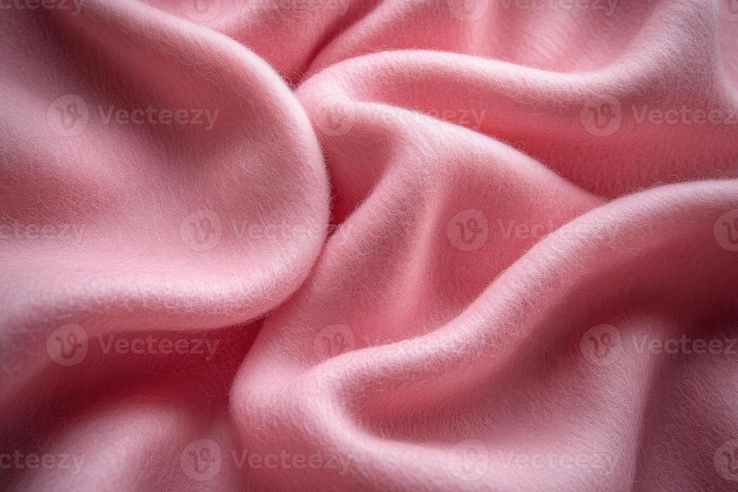 Soft, pink fabric draping elegantly across a surface, displaying smooth texture and gentle folds photo