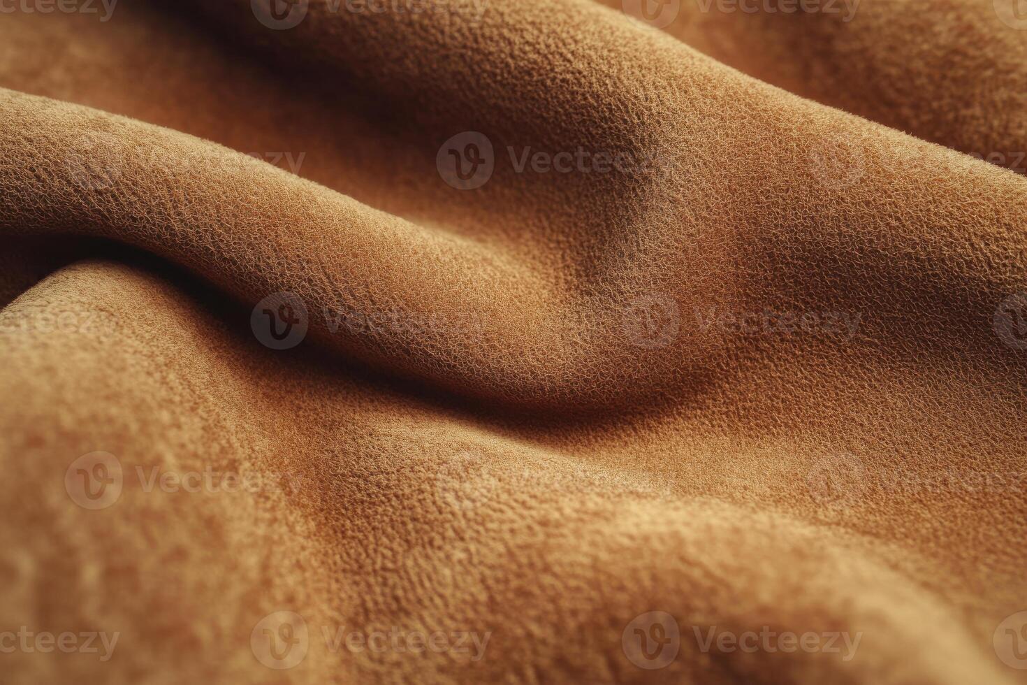 Soft brown suede fabric draped elegantly showcasing texture and color variations photo