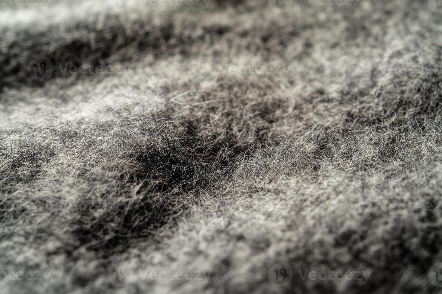 Close-up of textured gray fabric showcasing soft fibers and intricate patterns under natural light photo