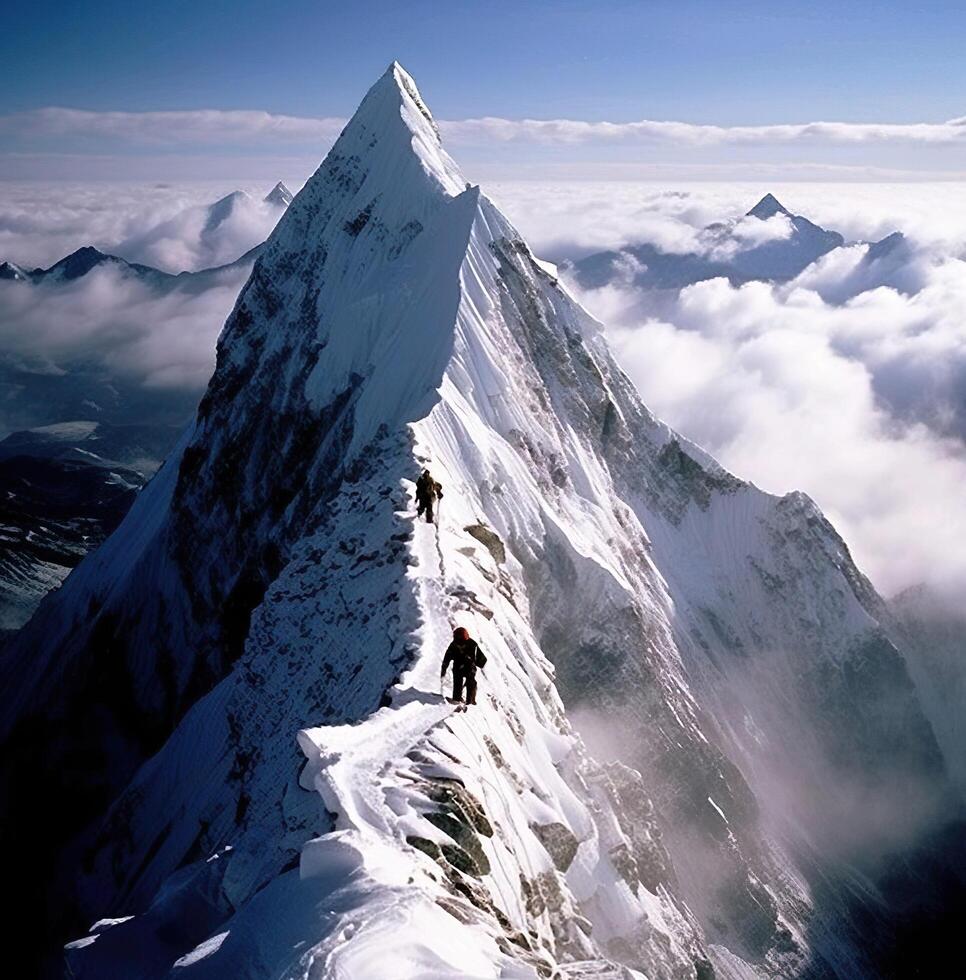 A man is climbing up a mountain with a snow covered peak photo