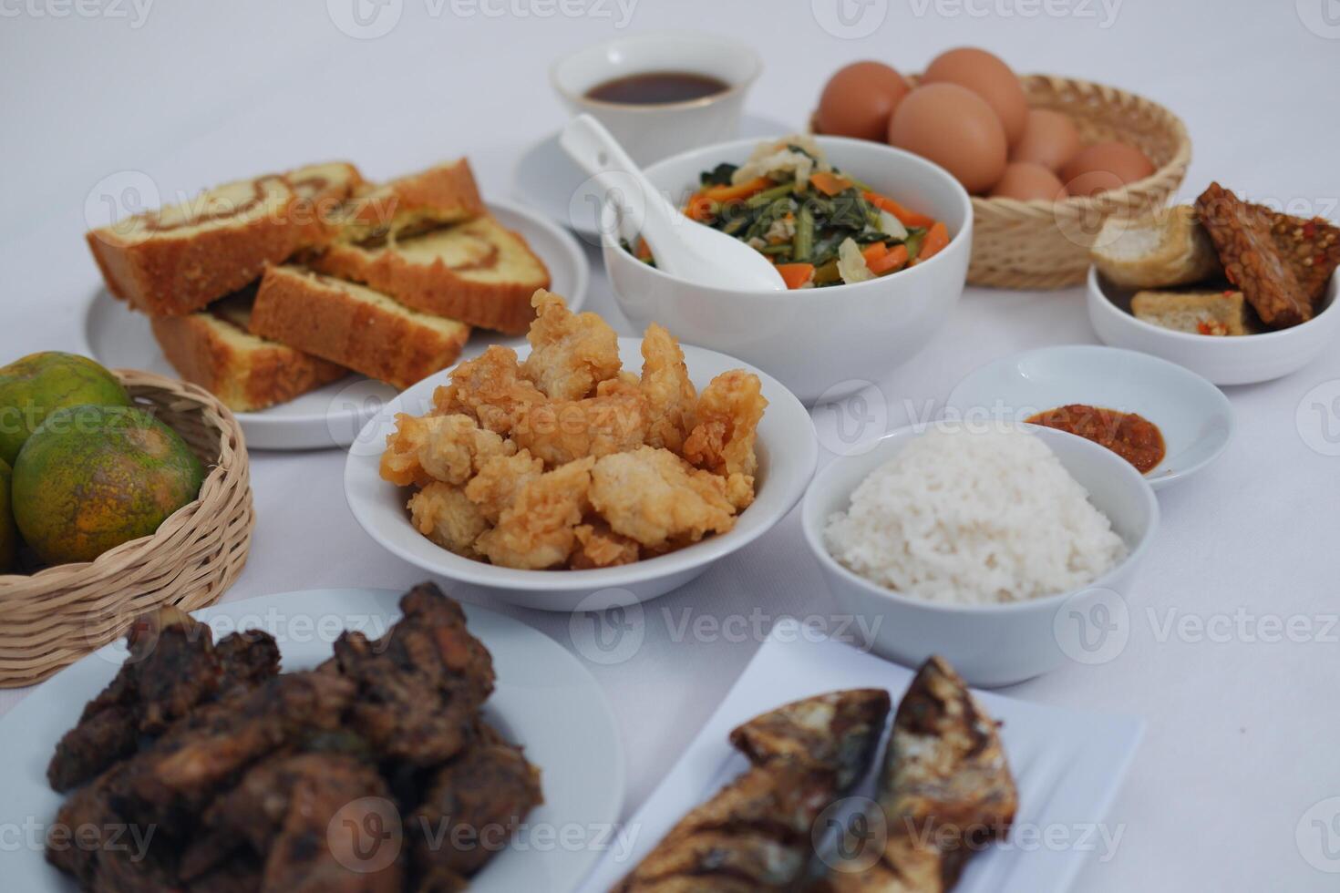 traditional Indonesian food arranged neatly on a white surface photo