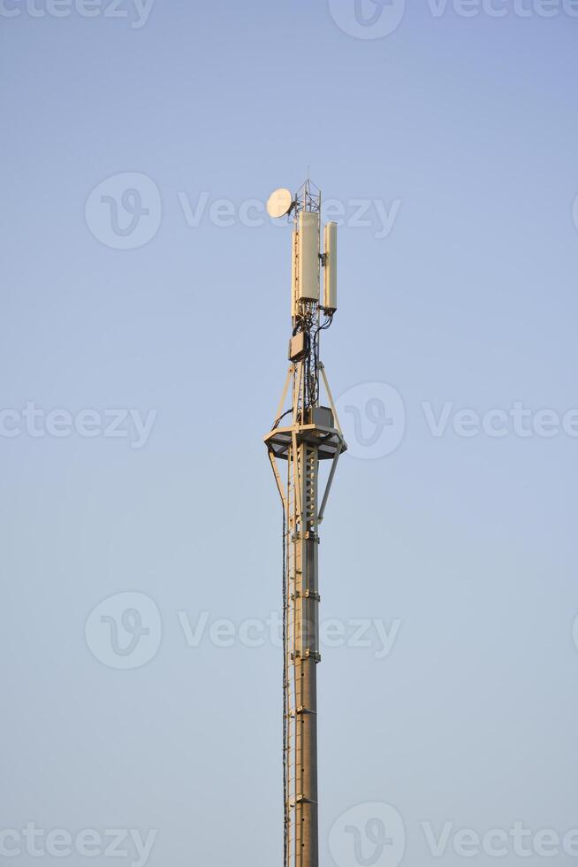 Telecommunication tower. Mobile phone tower with 5G cellular network . Global connection and internet network concept. City satellite tower. photo