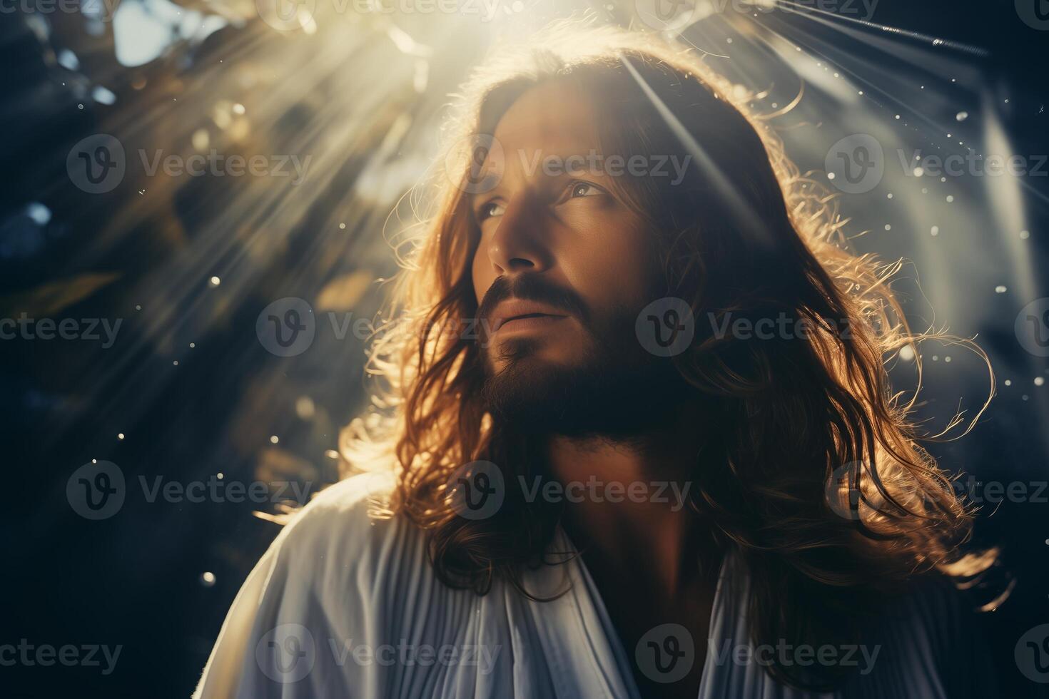 A man with long hair standing in front of a bright light source, casting a shadow on the ground. photo