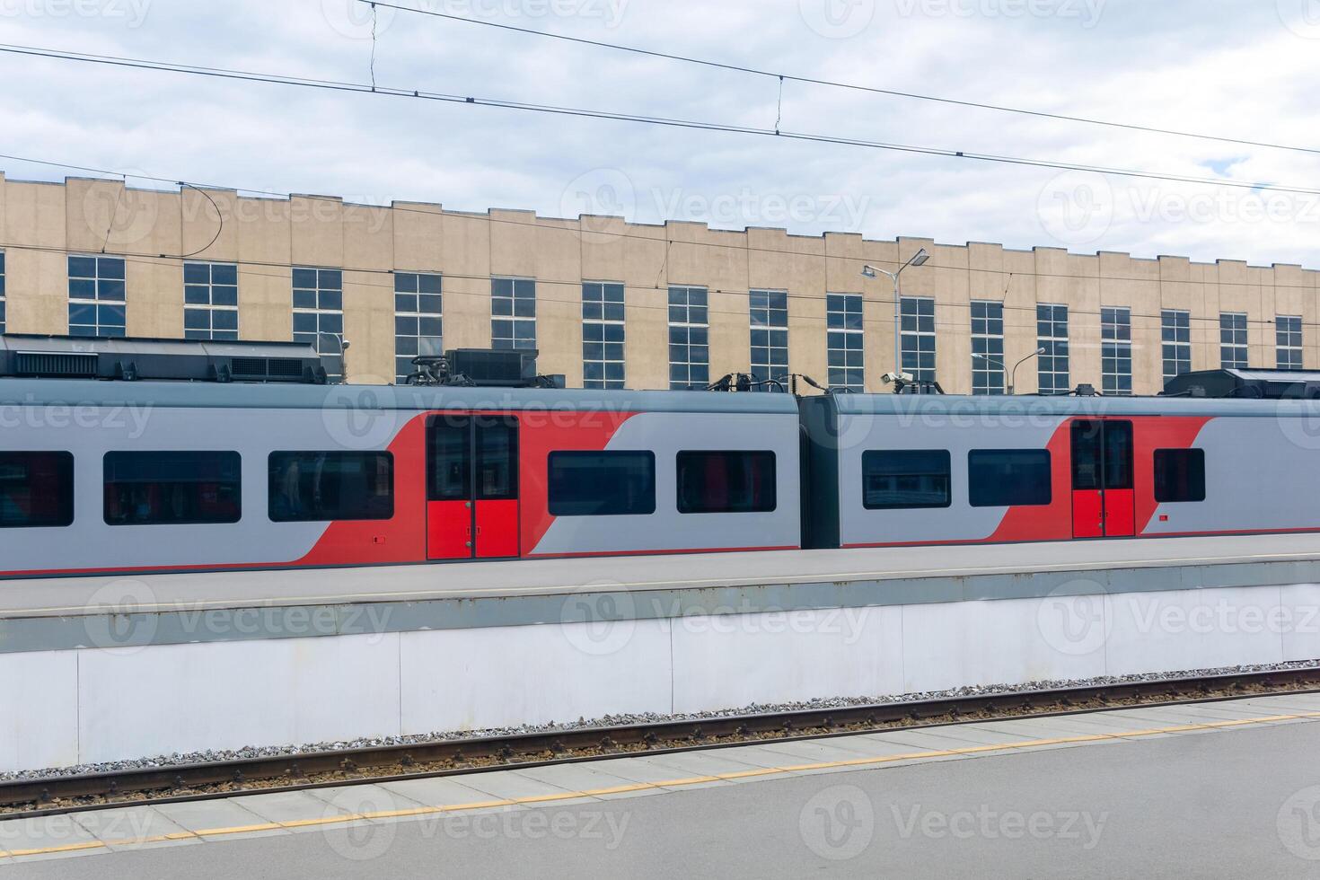 suburban electric train stands on the station photo