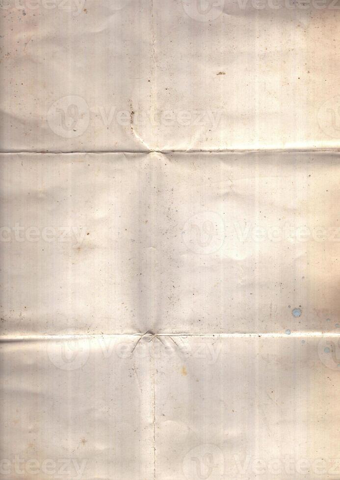 Interesting texture of old paper, soiled and damaged, as well as darkened by time and use, on a white background. Unique vintage texture of old paper which is approximately 60-70 years old. photo