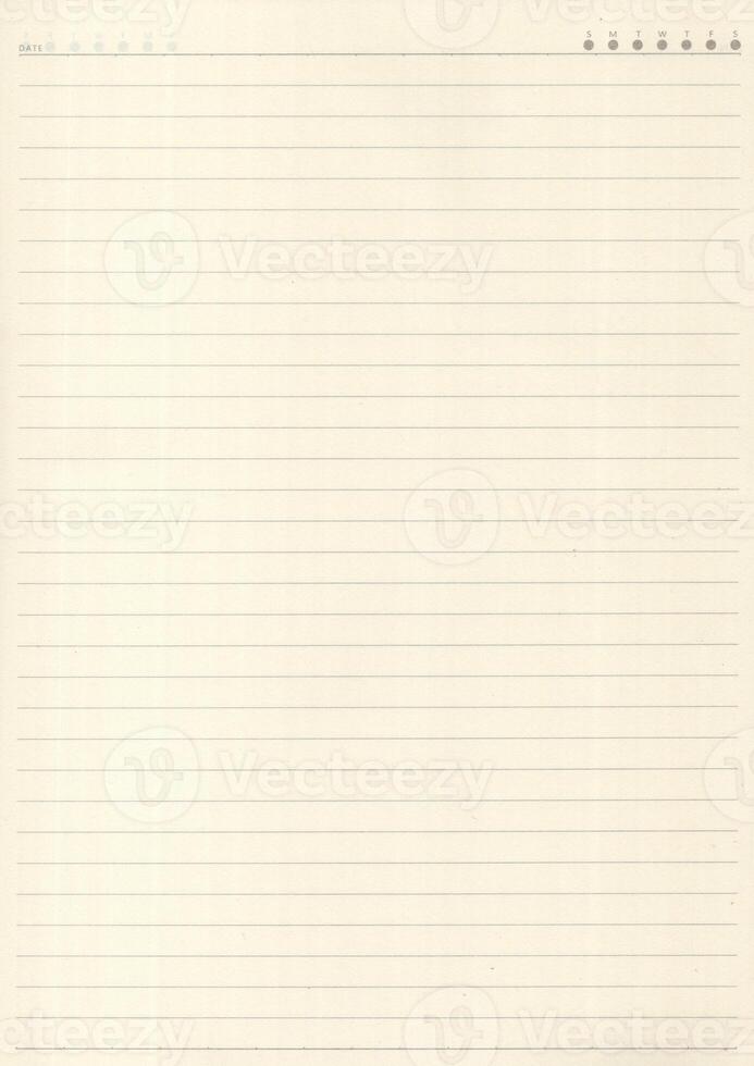 Yellow lined exercise paper with a ruled margin line running down it photo