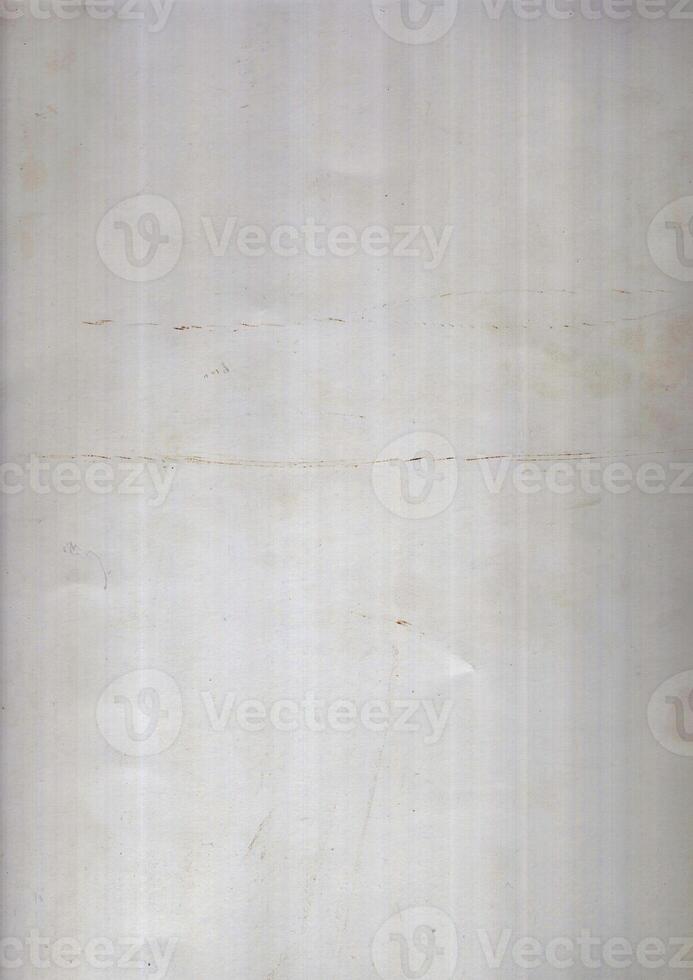 Interesting texture of old paper, soiled and damaged, as well as darkened by time and use, on a white background. Unique vintage texture of old paper which is approximately 60-70 years old. photo
