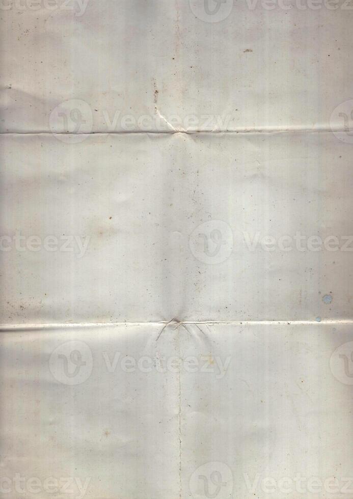 Interesting texture of old paper, soiled and damaged, as well as darkened by time and use, on a white background. Unique vintage texture of old paper which is approximately 60-70 years old. photo