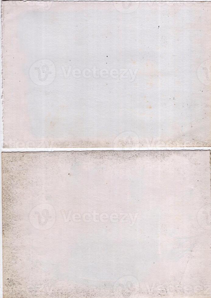 Interesting texture of old paper, soiled and damaged, as well as darkened by time and use, on a white background. Unique vintage texture of old paper which is approximately 60-70 years old. photo