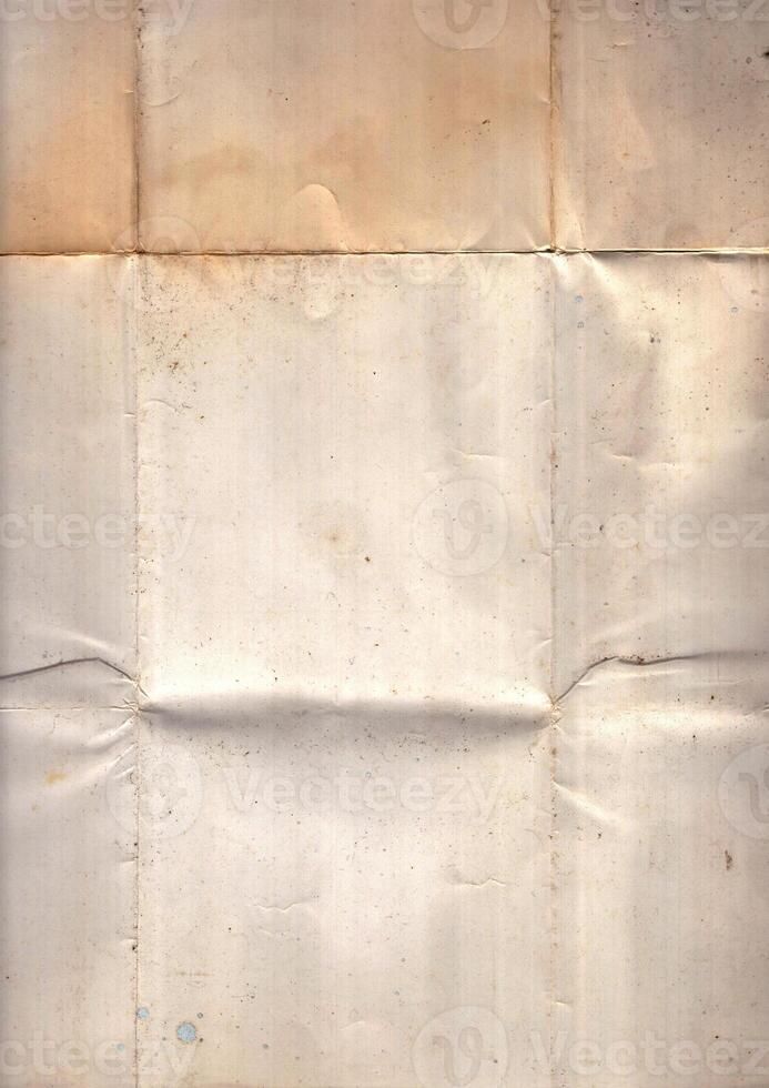 Interesting texture of old paper, soiled and damaged, as well as darkened by time and use, on a white background. Unique vintage texture of old paper which is approximately 60-70 years old. photo