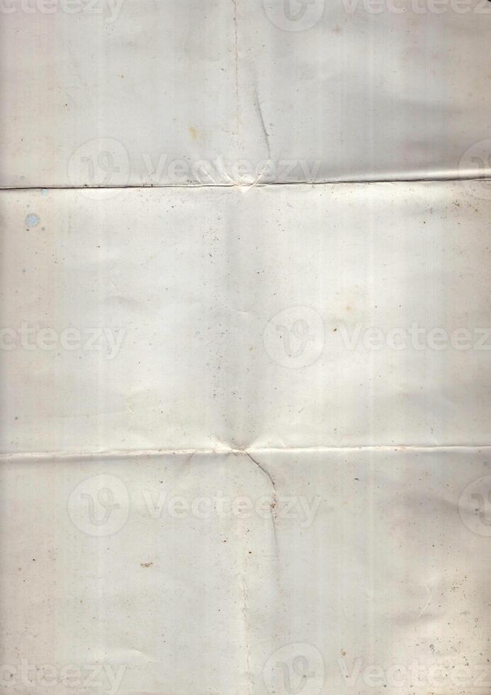 Interesting texture of old paper, soiled and damaged, as well as darkened by time and use, on a white background. Unique vintage texture of old paper which is approximately 60-70 years old. photo