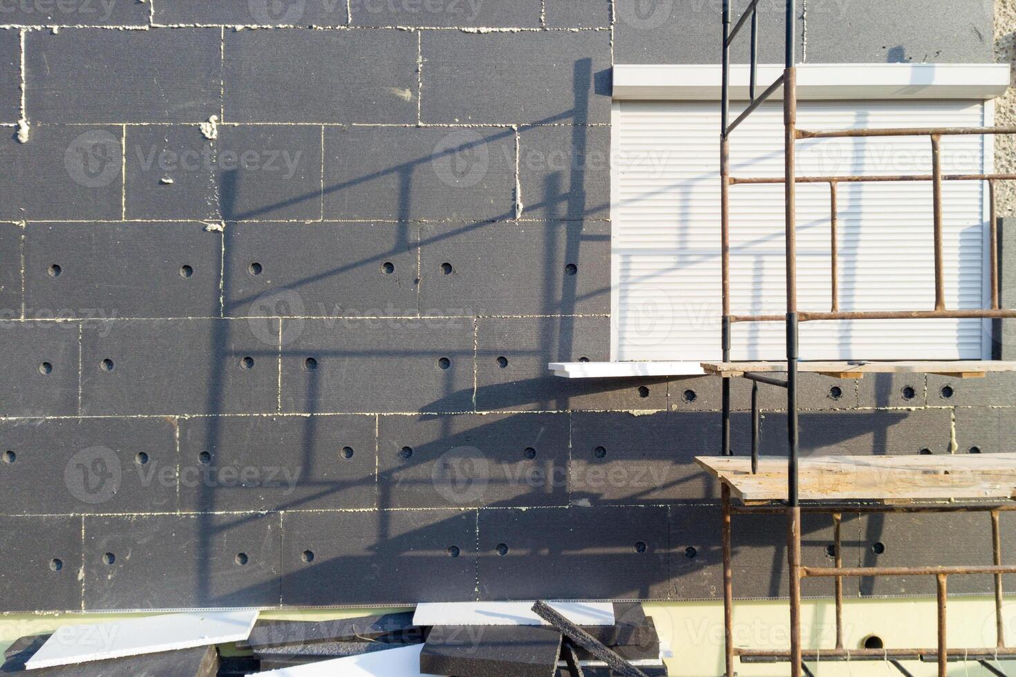 Scaffold and exterior insulation work on building facade photo