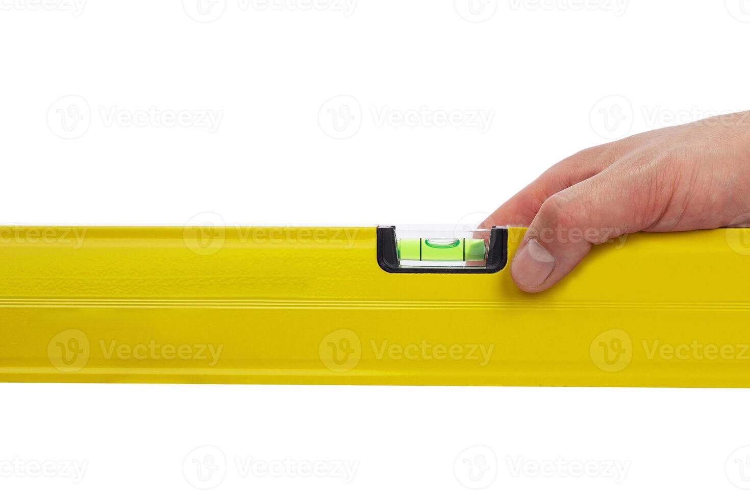 Hand holding yellow level tool isolated on white background photo
