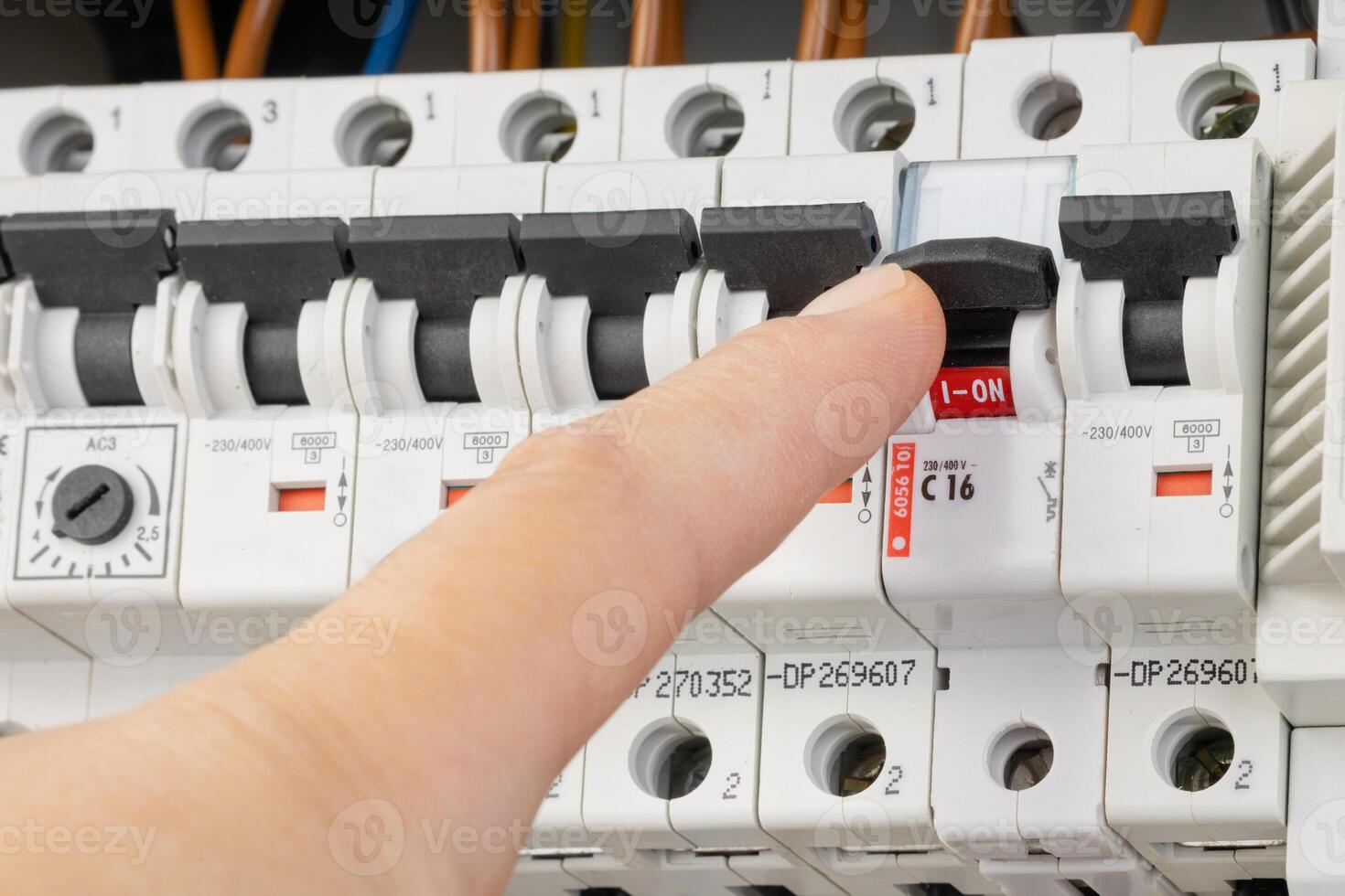 Testing circuits with probes in an electrical panel photo