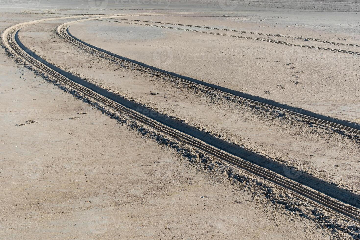 rough tire tracks on the north sea beach photo
