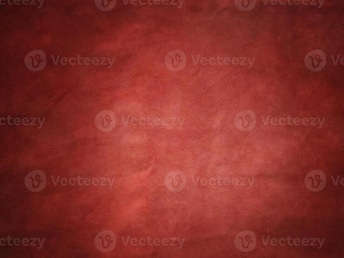 Red suede vignette edge dark and light in the center of the frame. photo