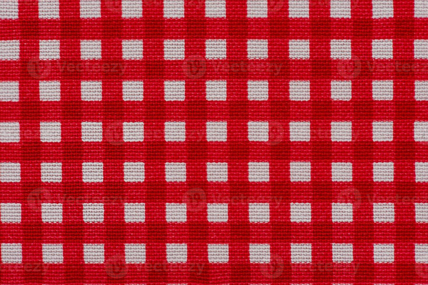 Checkered fabric white with red as background macro photo. photo