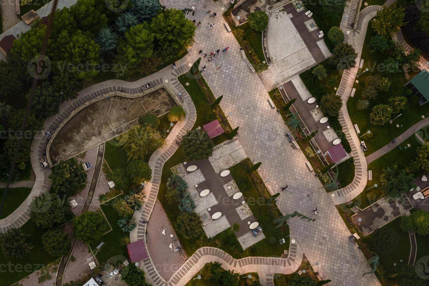 Top view of a beautiful landscaped park during sunset with winding paths and gathering places photo