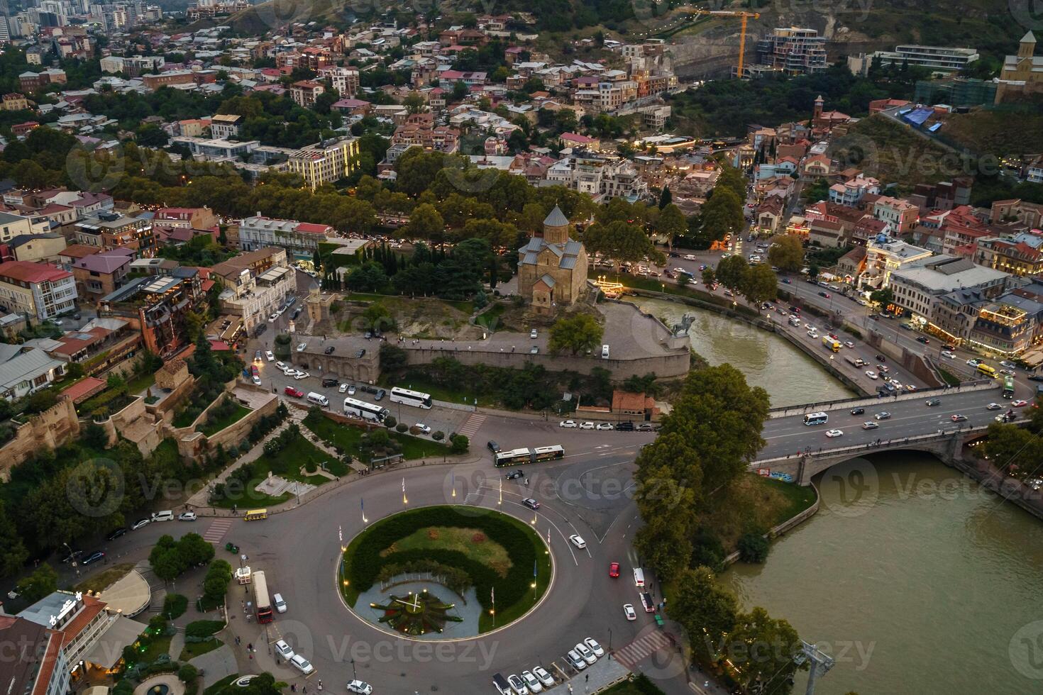 An aerial view of Tbilisis bustling cityscape at twilight encompassing historical architecture photo