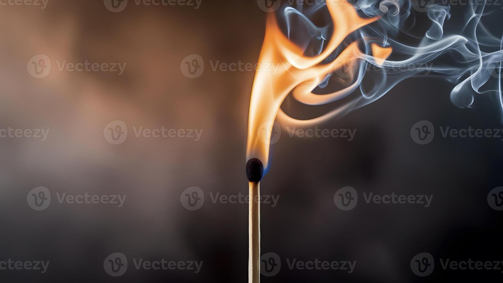 A burning match on a dark background photo