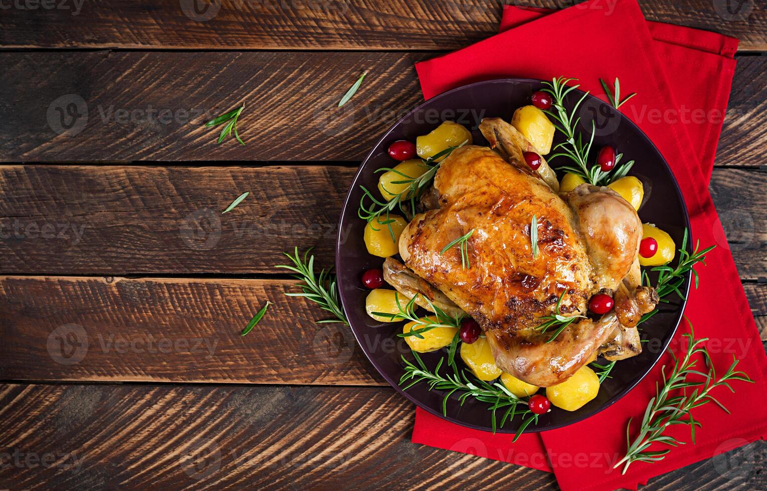 Baked chicken or baked turkey. The Christmas table is served with a turkey. Fried chicken, table setting. Christmas dinner. Flat lay. Top view photo