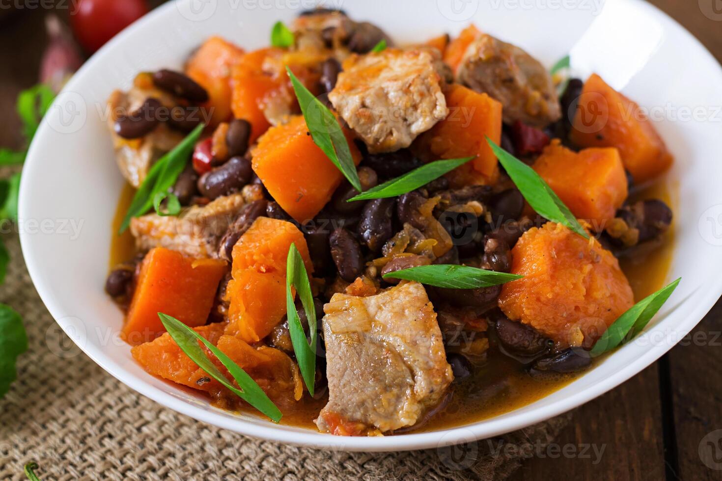Baked spicy pumpkin with meat and beans photo