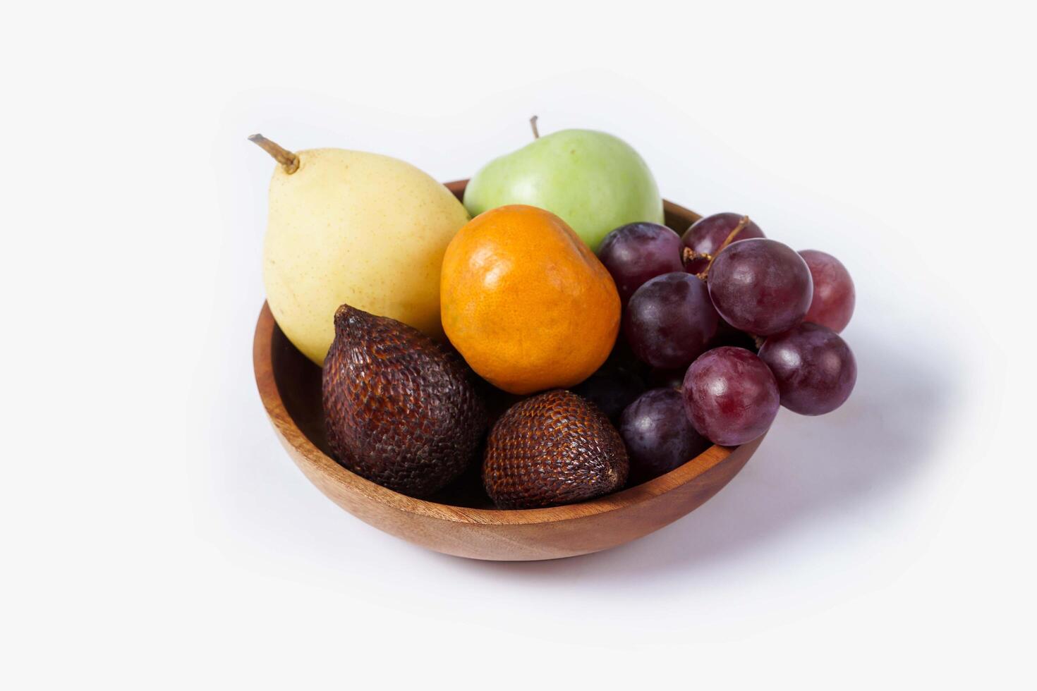 Assortment of exotic fruits isolated on white background. Close up of heap of fruit. Concept of healthy eating and dieting lifestyle. photo