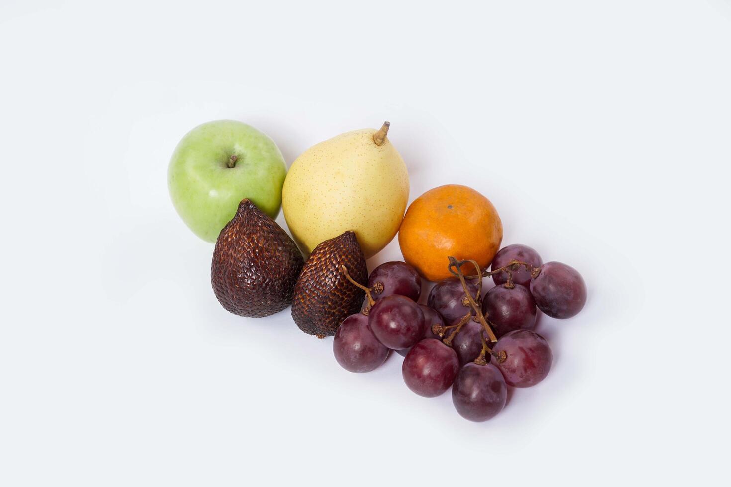 Assortment of exotic fruits isolated on white background. Close up of heap of fruit. Concept of healthy eating and dieting lifestyle. photo