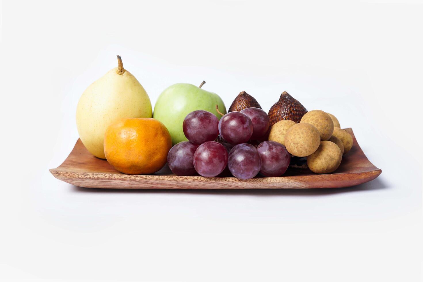 Assortment of exotic fruits isolated on white background. Close up of heap of fruit. Concept of healthy eating and dieting lifestyle. photo