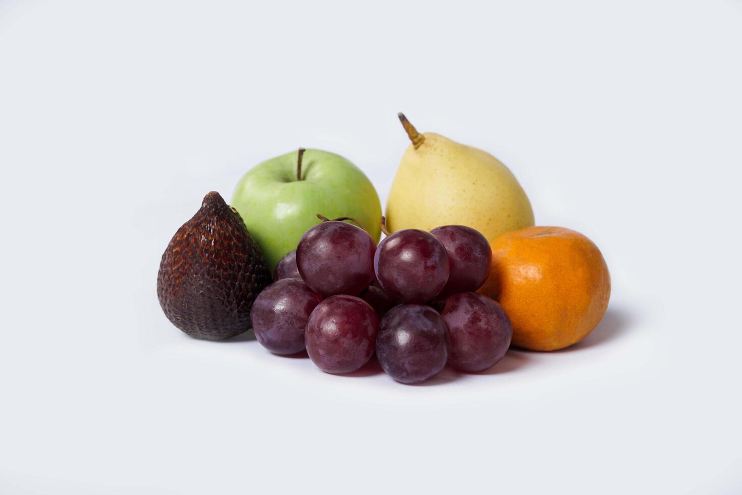 Assortment of exotic fruits isolated on white background. Close up of heap of fruit. Concept of healthy eating and dieting lifestyle. photo