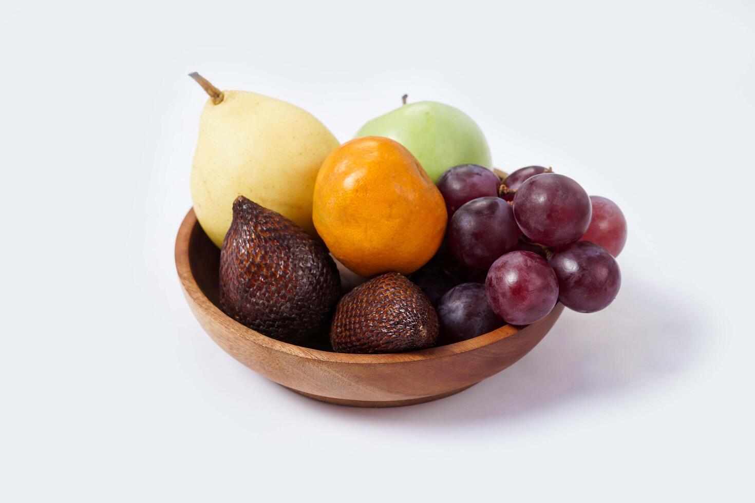 Assortment of exotic fruits isolated on white background. Close up of heap of fruit. Concept of healthy eating and dieting lifestyle. photo