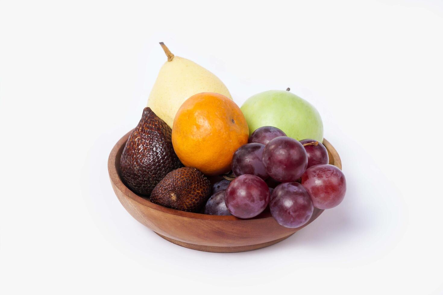 Assortment of exotic fruits isolated on white background. Close up of heap of fruit. Concept of healthy eating and dieting lifestyle. photo