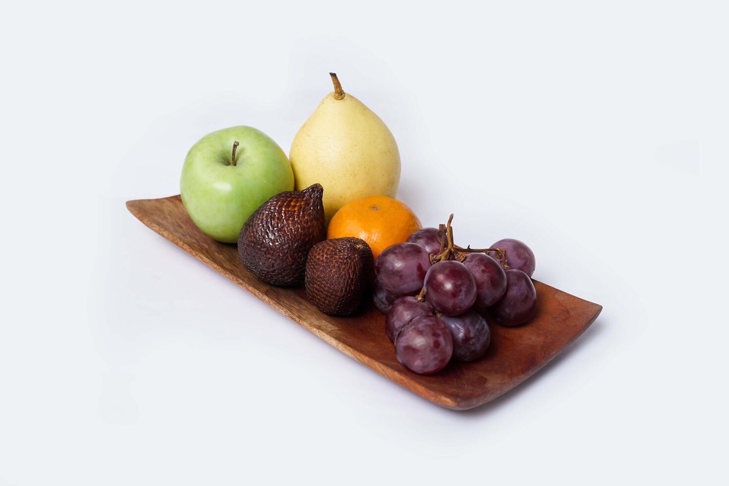 Assortment of exotic fruits isolated on white background. Close up of heap of fruit. Concept of healthy eating and dieting lifestyle. photo
