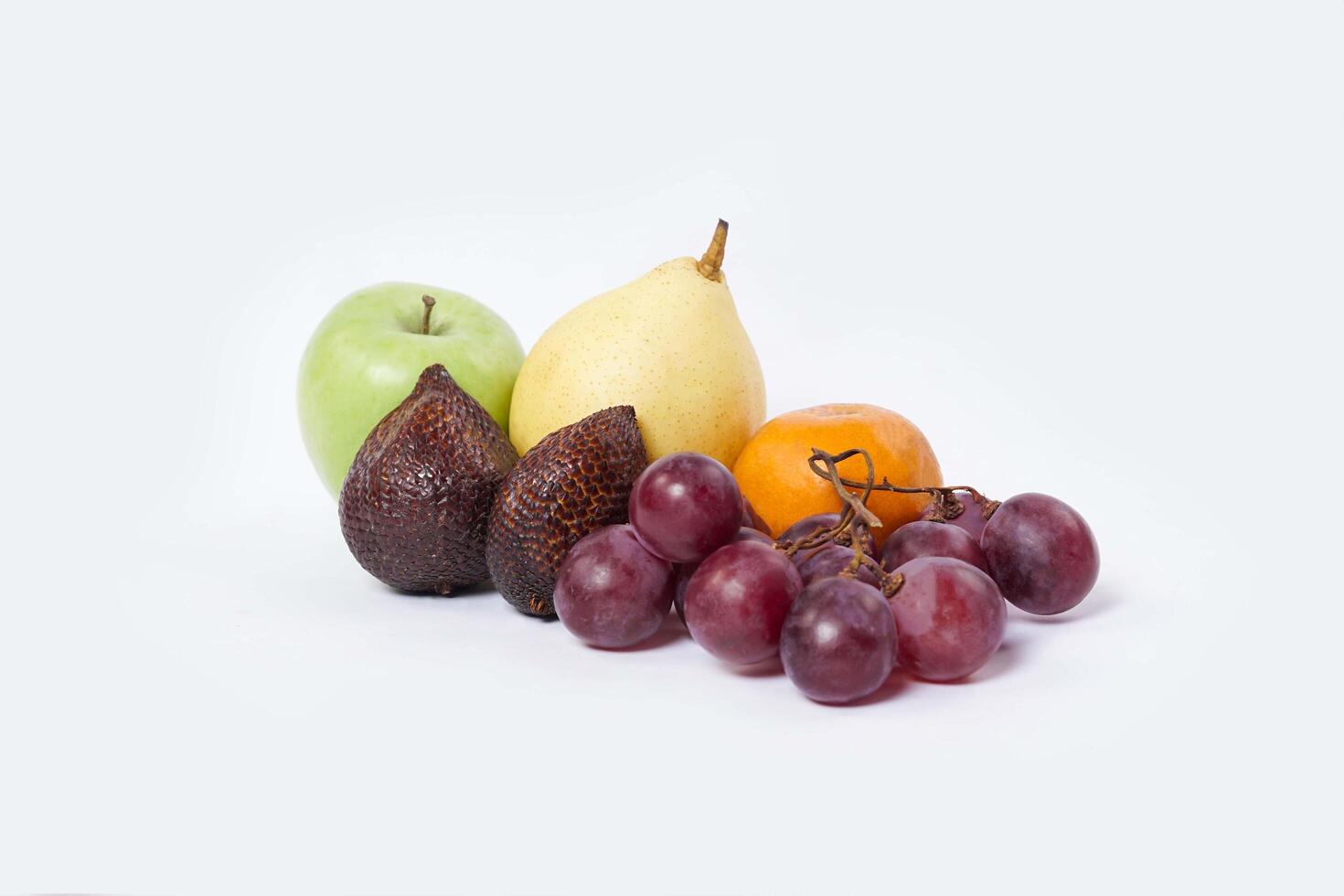 Assortment of exotic fruits isolated on white background. Close up of heap of fruit. Concept of healthy eating and dieting lifestyle. photo