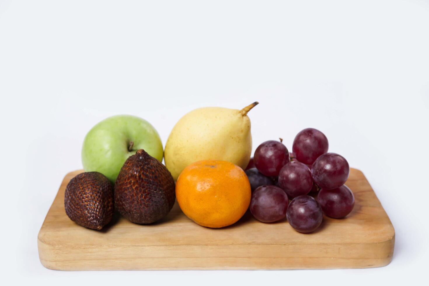 Assortment of exotic fruits isolated on white background. Close up of heap of fruit. Concept of healthy eating and dieting lifestyle. photo