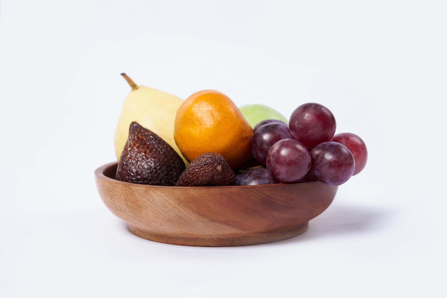 Assortment of exotic fruits isolated on white background. Close up of heap of fruit. Concept of healthy eating and dieting lifestyle. photo