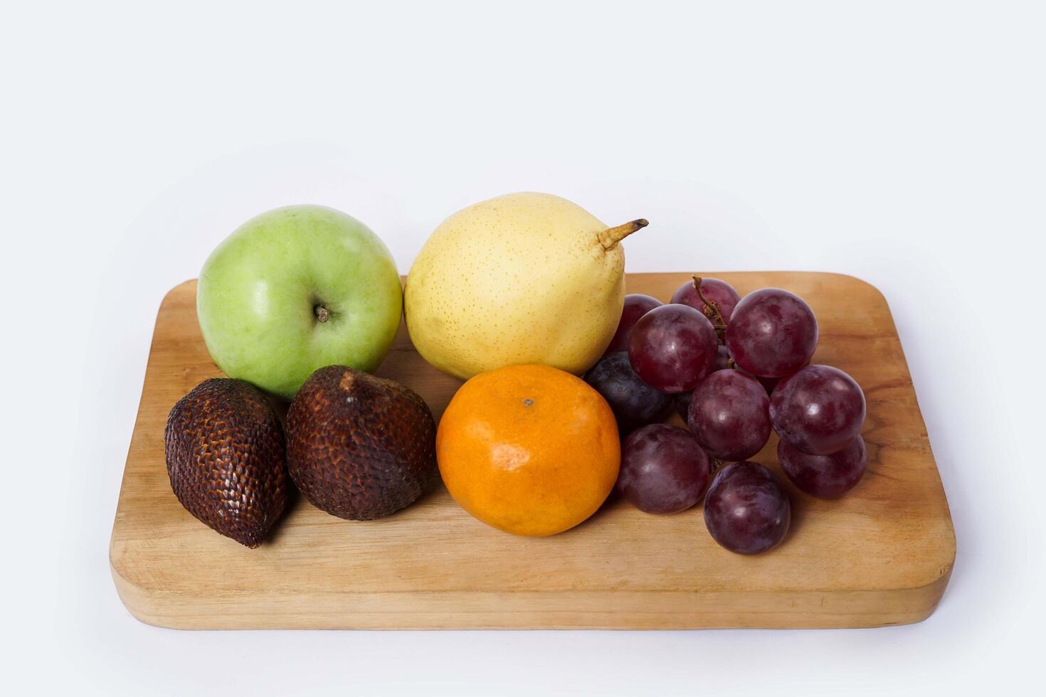 Assortment of exotic fruits isolated on white background. Close up of heap of fruit. Concept of healthy eating and dieting lifestyle. photo
