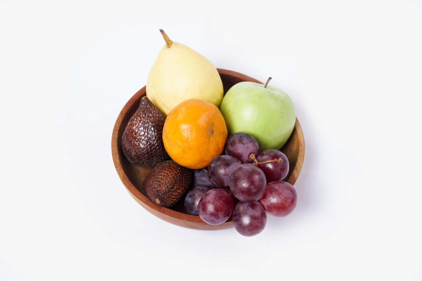 Assortment of exotic fruits isolated on white background. Close up of heap of fruit. Concept of healthy eating and dieting lifestyle. photo