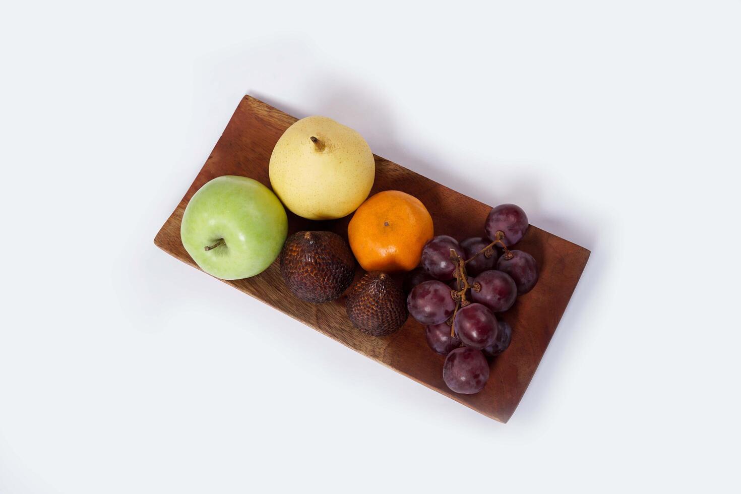 Assortment of exotic fruits isolated on white background. Close up of heap of fruit. Concept of healthy eating and dieting lifestyle. photo