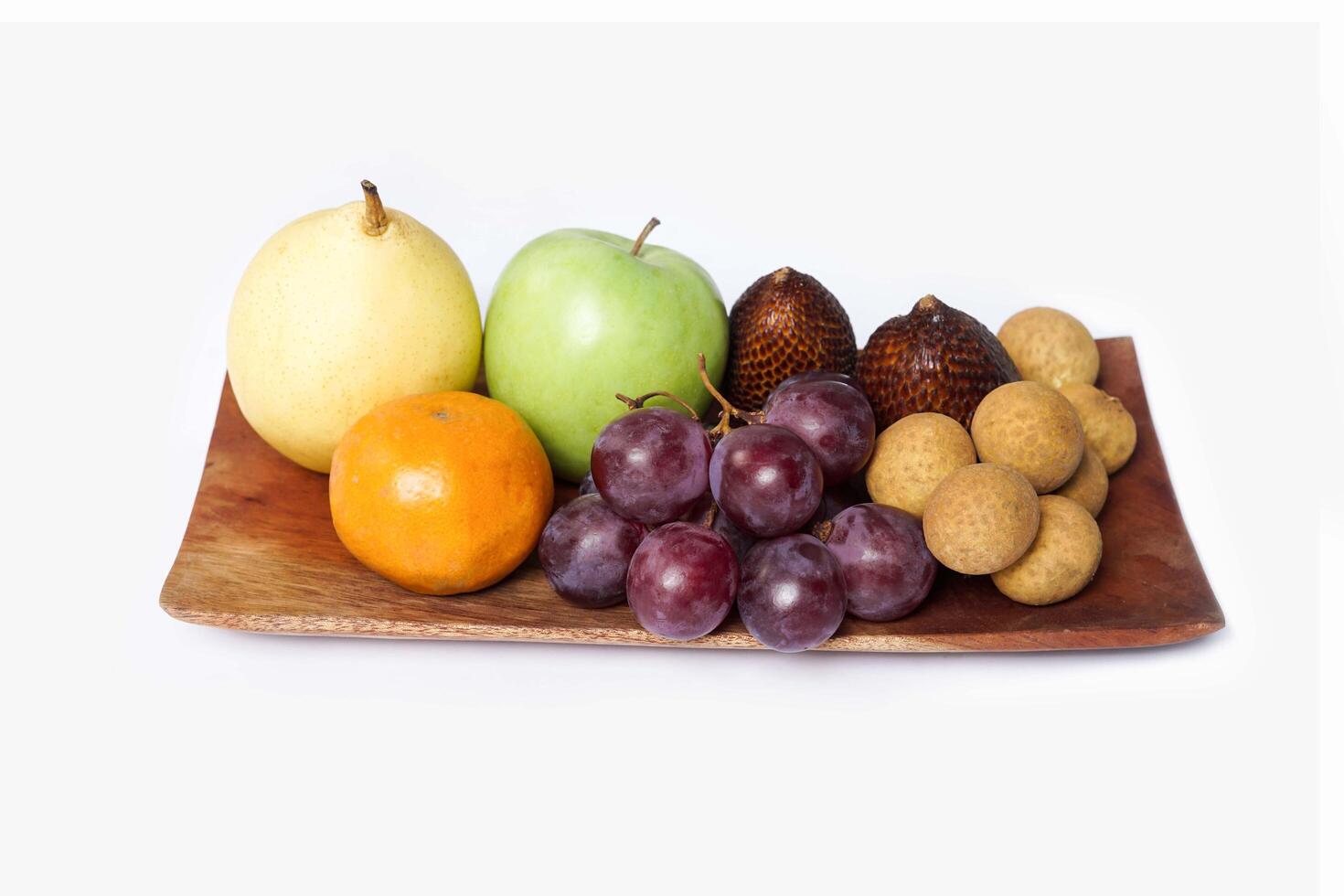 Assortment of exotic fruits isolated on white background. Close up of heap of fruit. Concept of healthy eating and dieting lifestyle. photo