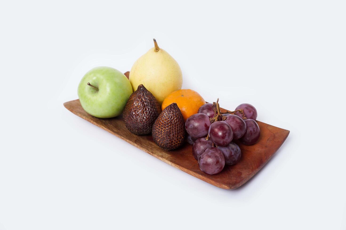 Assortment of exotic fruits isolated on white background. Close up of heap of fruit. Concept of healthy eating and dieting lifestyle. photo