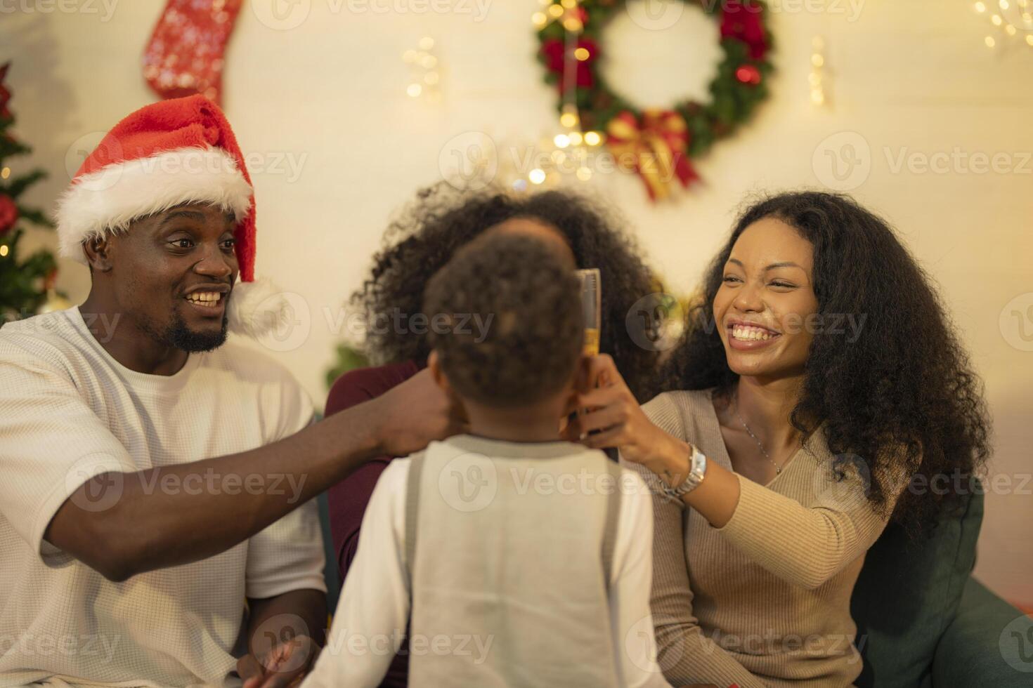A lively Christmas celebration with three african friends enjoying drinks and holiday cheer on a sofa. The festive atmosphere includes Christmas trees, wreaths, lights, and decorations. photo