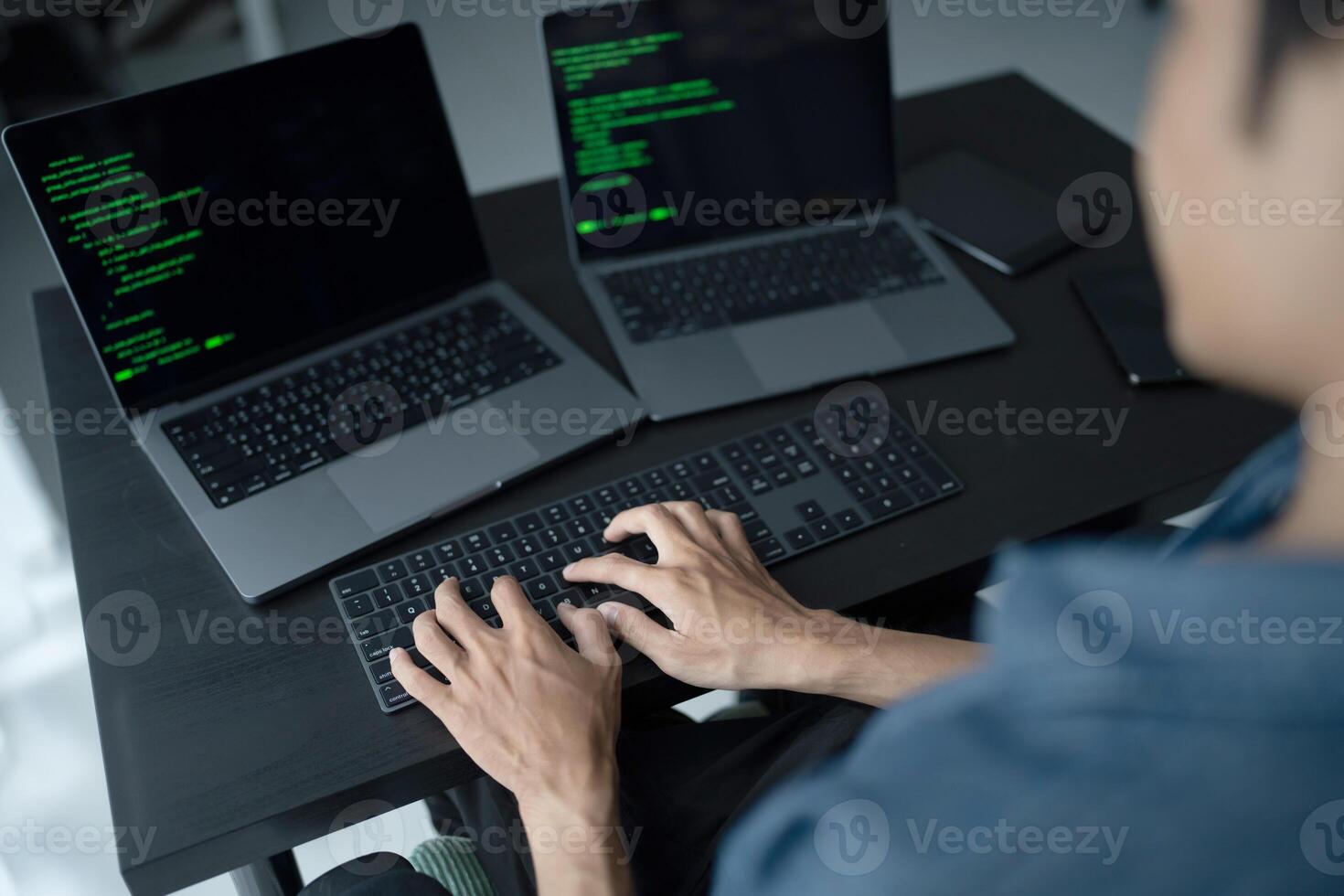 Asian man software engineer Working on Computer at office desk for writing program code IT Software Engineer finding errors tech support devops creating digital photo