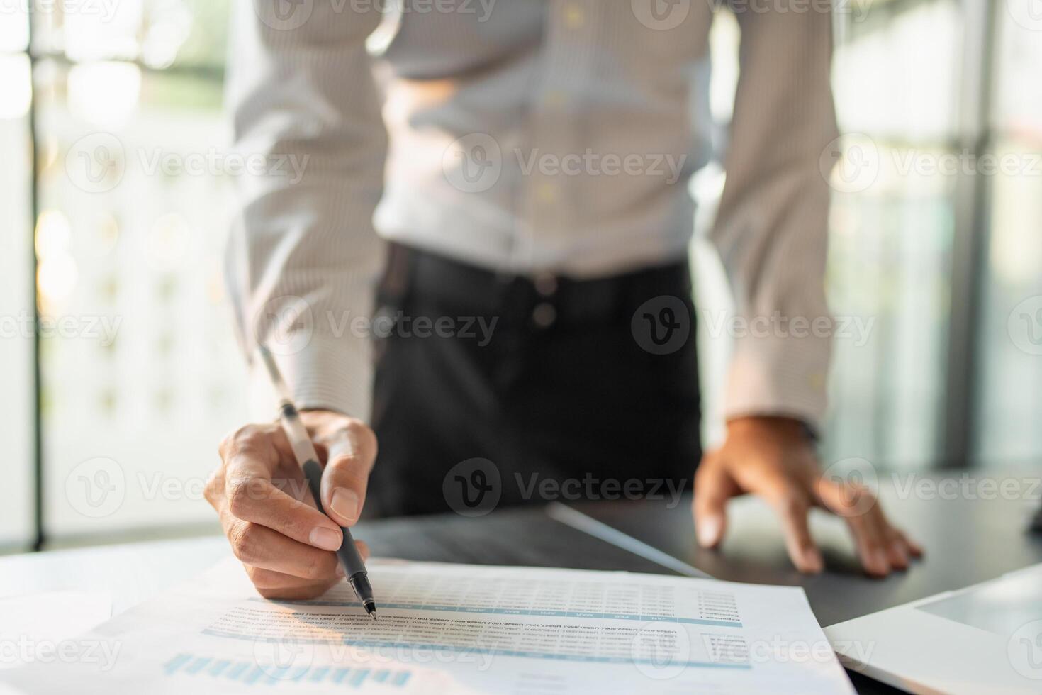 Close up of businessman hands signing or writing document paperwork and report Auditor analysis male professional hand making notes with Business Document. photo