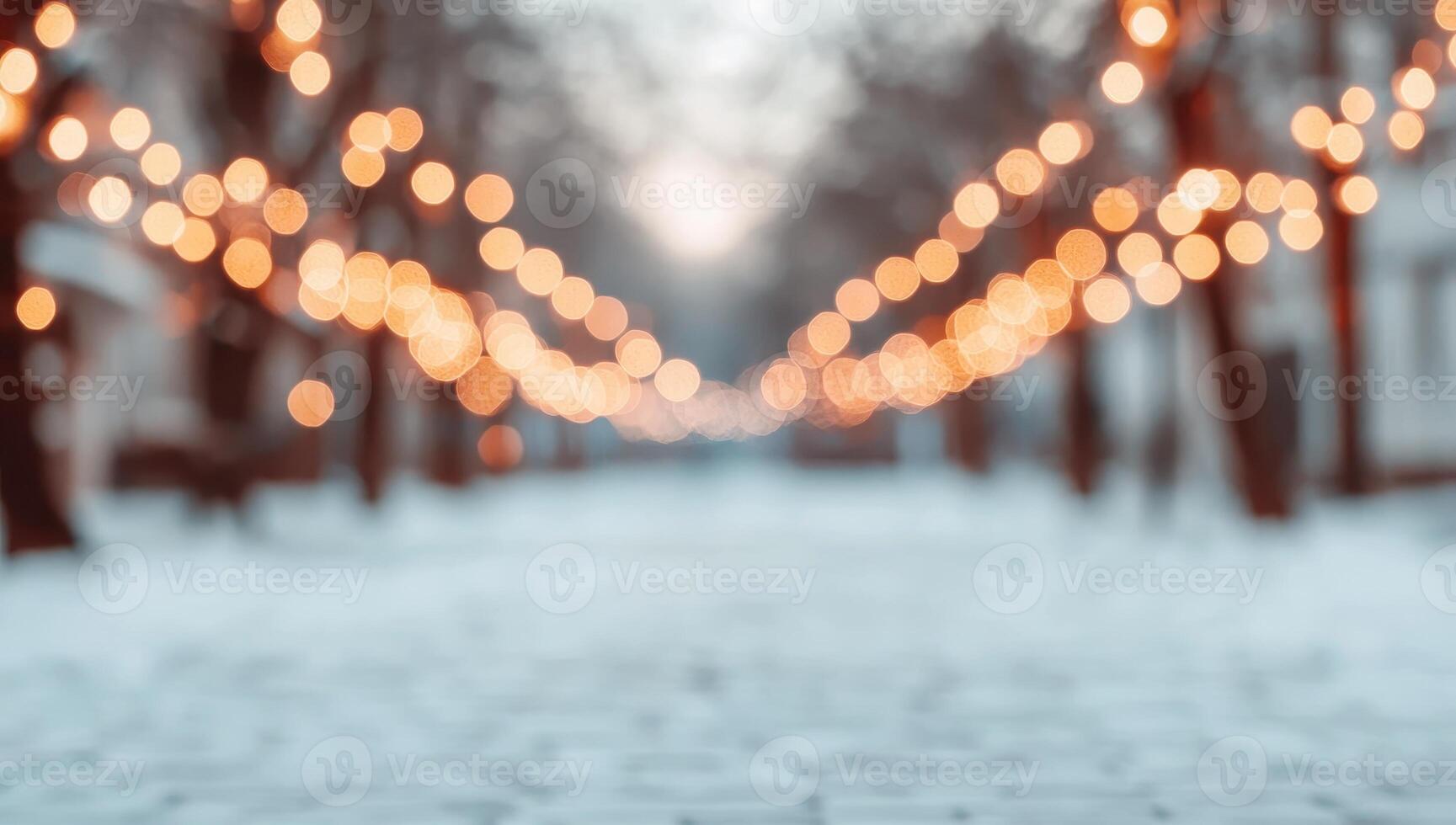 Blurred winter background of snowy city park alley with glowing lights garland on trees. Festive Christmas New Year holiday decorations, bokeh, evening illumination, snowfall. photo