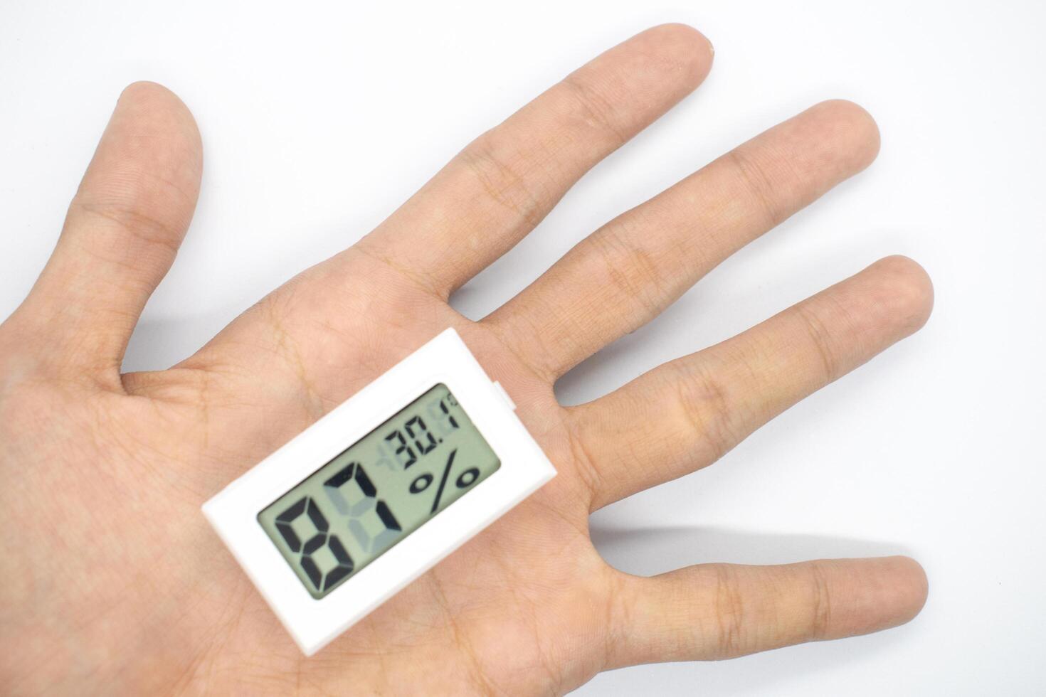 humidity measuring thermometer, small size, portable, with a white background. photo