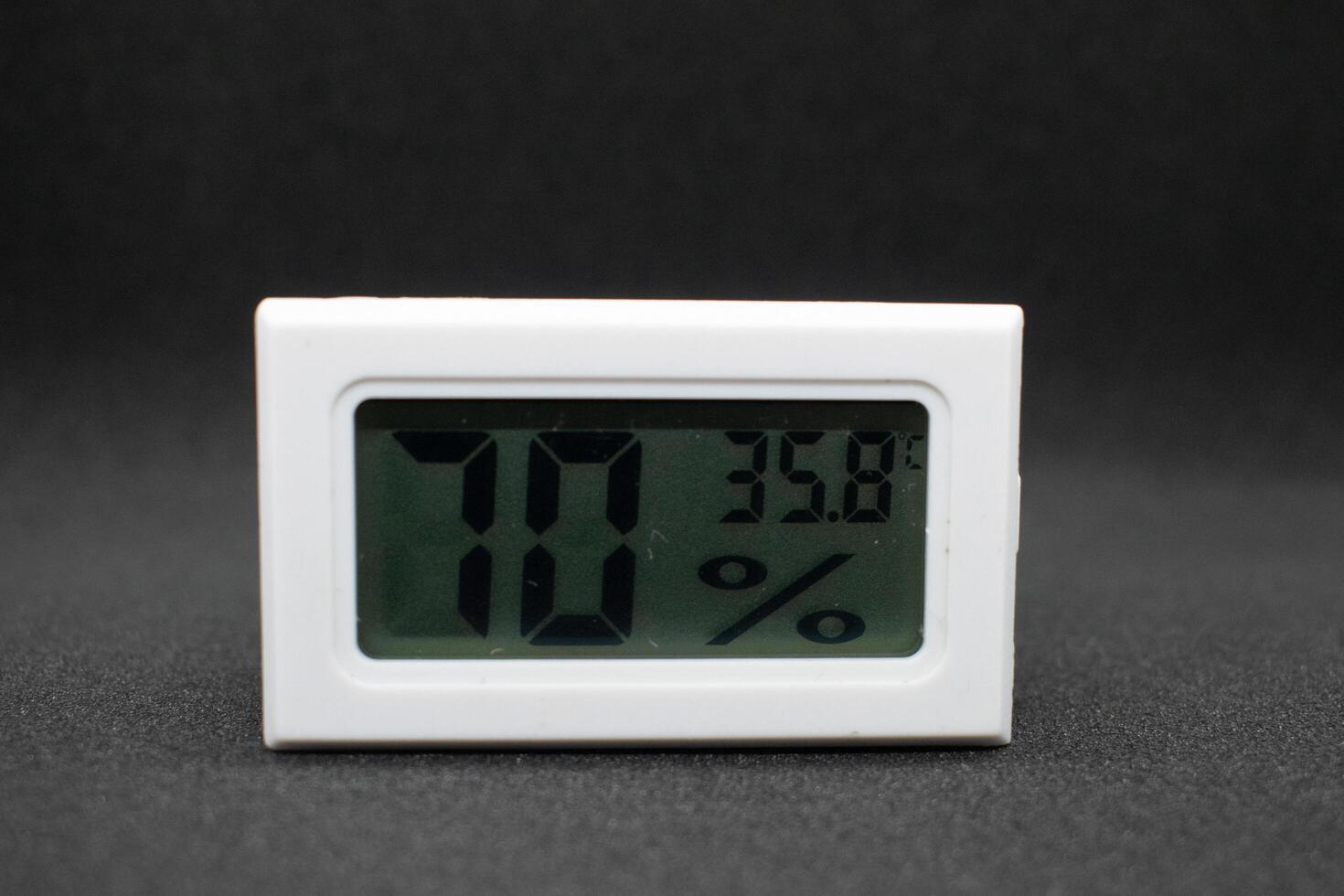 humidity measuring thermometer, small size, portable, with black background. photo